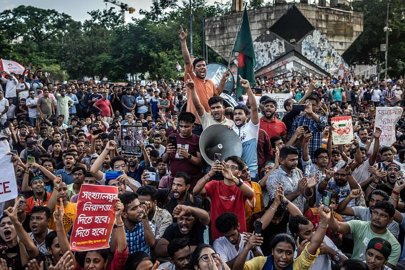 Members of the Bangladeshi Hindu community hold banners and chant slogans against violence targeting the country’s minorities during a protest in Dhaka on 9 August 2024, days after a student-led uprising ended the 15-year rule of Sheikh Hasina. Some businesses and homes owned by Hindus were attacked following Hasina’s ousting, and the group is seen by some in Muslim-majority Bangladesh as having been close to Hasina